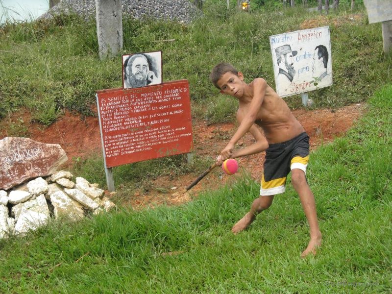 Viñales boy playing baseball swing swinging sign propoganda fidel castro