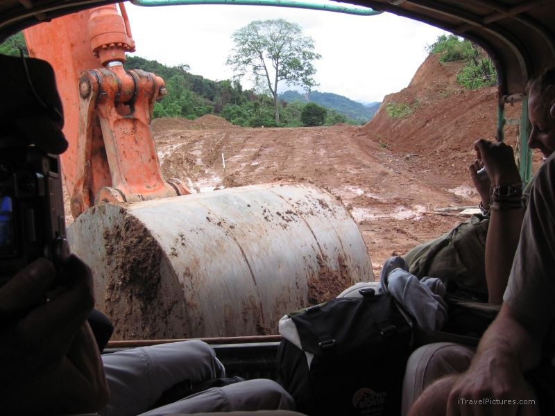road push pushing mud backhoe
