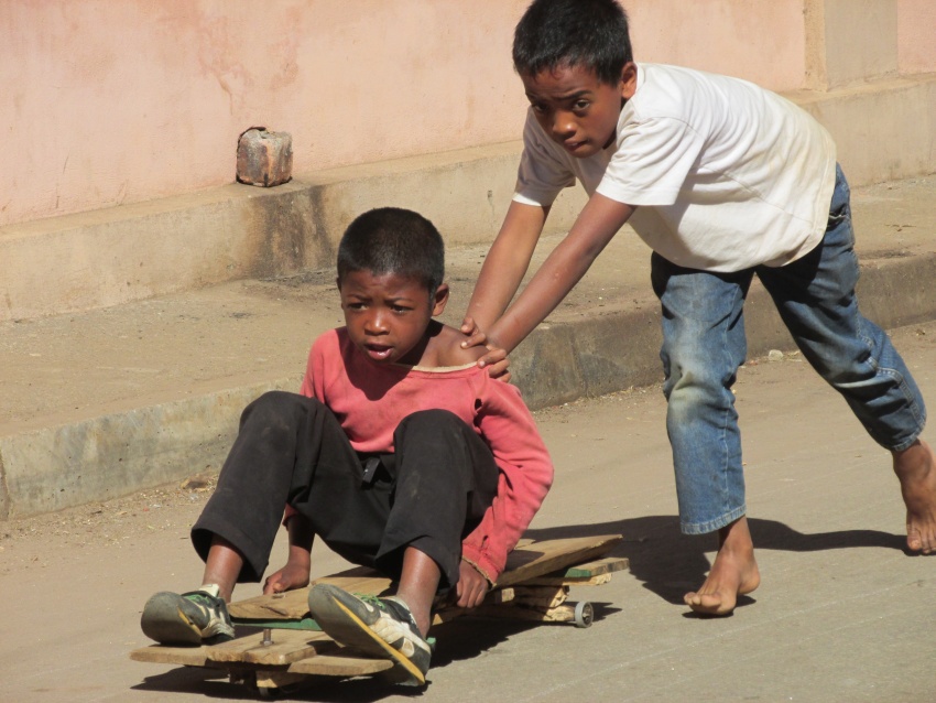 oys playing skateboard cart