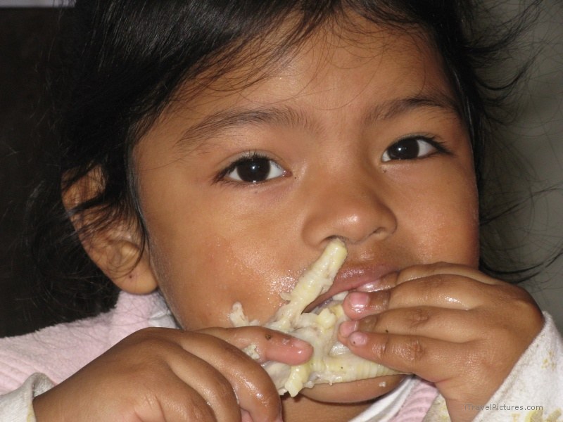 girl eating chicken foot