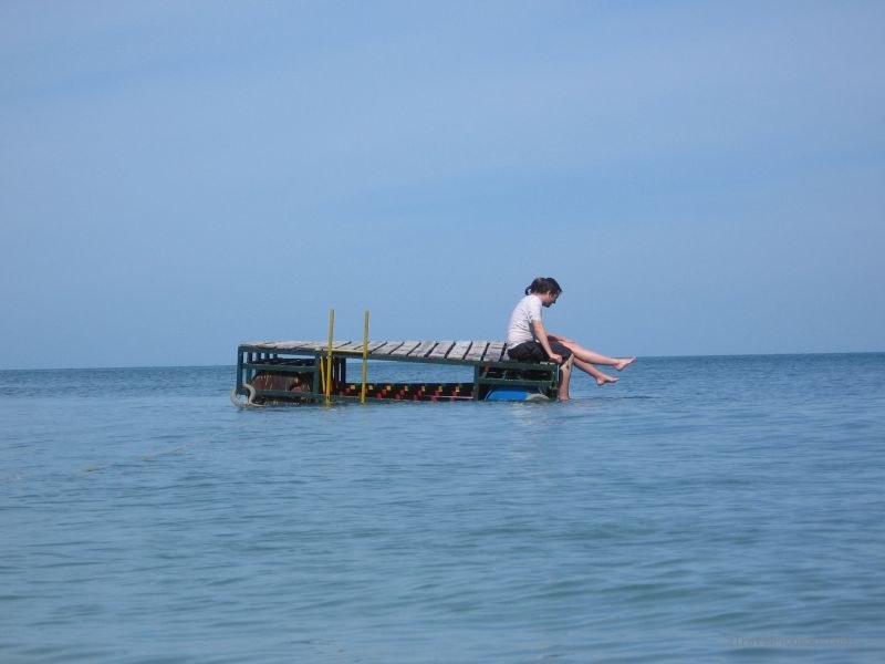 Hat Thian couple sitting dock ocean